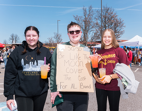 A trio of people at Avon Lake before the eclipse