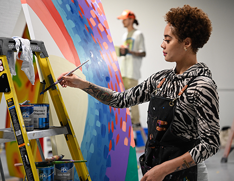 An artist painting the used wind turbines. 