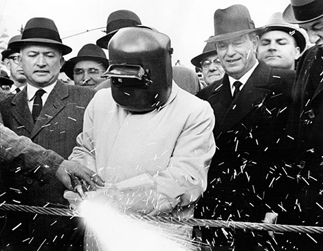 Mayor Anthony Celebrezze firing up an acetylene torch and cutting through a one-inch cable. Mayor Anthony Celebrezze firing up an acetylene torch and cutting through a one-inch cable.