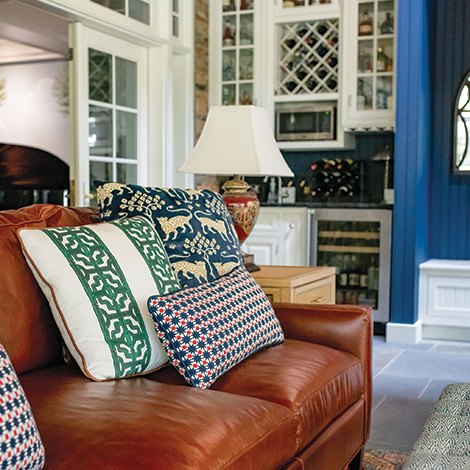 One of the many sofas inside the home with pillows.