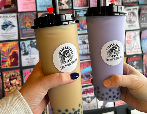 Two friends holding Boba drinks Two friends holding Boba drinks