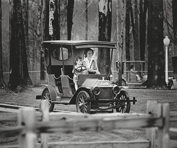 Two people driving a cart at Geauga Lake