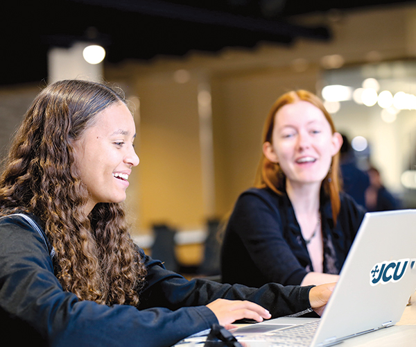 Two students at John Carroll University taking part in online learning