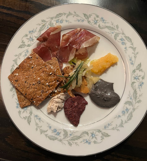 Beard Foundation. Jeremy Umanksy & Allie La Valle-Umansky of Larder Delicatessen and Bakery Midwest snack plate. Prosciutto, Lake Erie caviar, pickled mushroom, Ohio truffle, rolled oat chip.