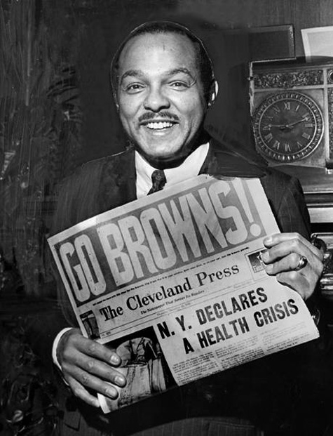 Mayor Carl B. Stokes holds a copy of the Cleveland Press