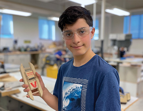 Parker Borland smiling and holding a mousetrap