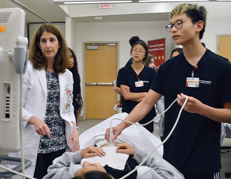 Kevin Zhang participating in hands on learning by performing an ultrasound