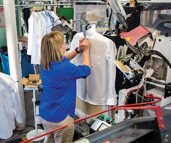 Woman buttoning dress shirt