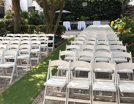 West-Article-Georgetown-Vosh White chairs set up for an outdoor wedding