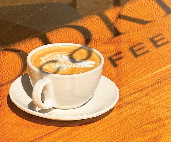 Mug of gourmet coffee on a wooden table