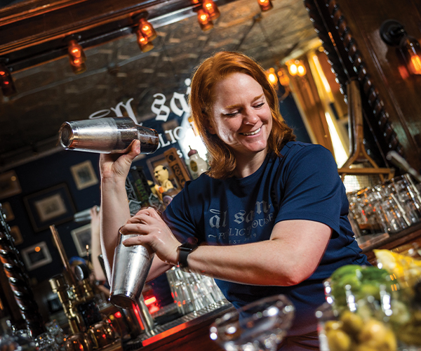 Katie Barto mixing a drink behind the bar