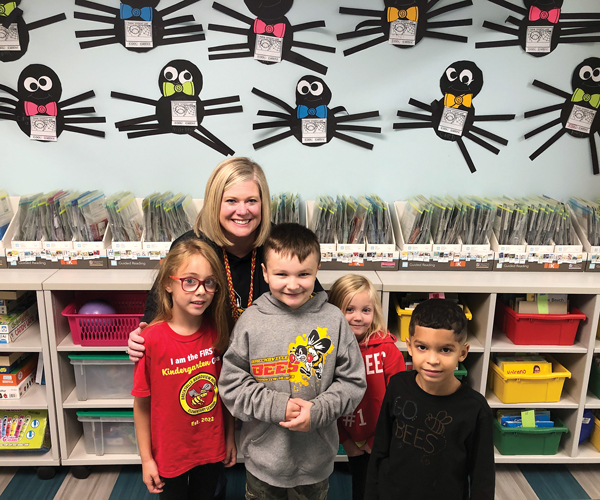 Principal Mrs. Toth smiles with a group of students at Brecksville Broadview Heights Elementary School