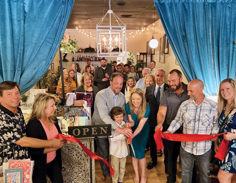 business-article-1811 A group of people standing around a ribbon cutting ceremony