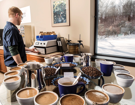 an array of Caruso's Coffee in mugs on a table