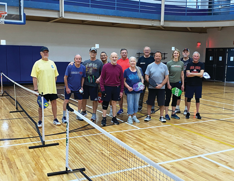pickleball-article A group of pickleball players smiling on the court