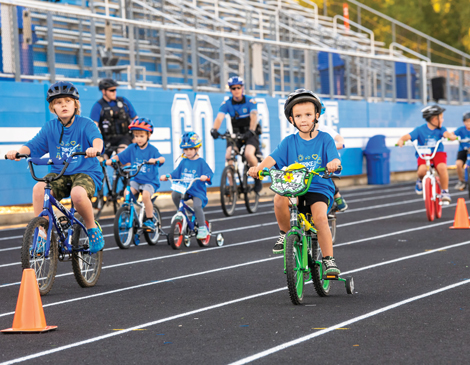 Kids in helmets riding bikes