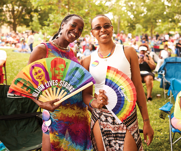 Women enjoying WOW! with colorful paper fans