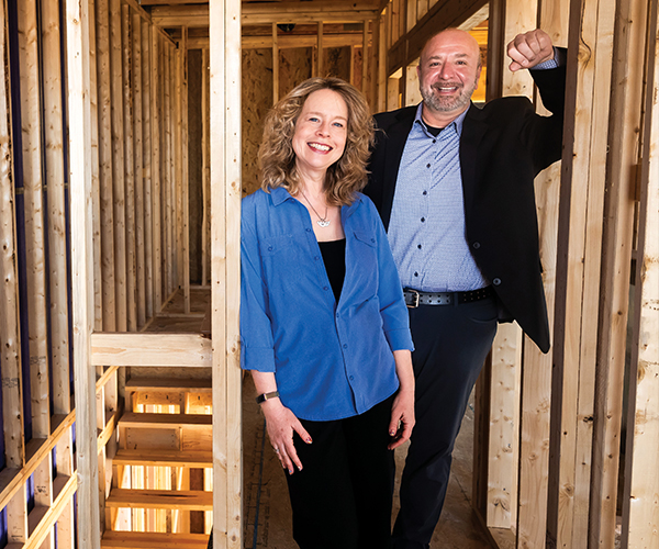 Carolyn Bentley and Ted Theophylactos standing in a home under construction