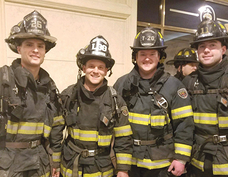 Zach Lapuh (far left) climbed stairs in full firefighter gear.