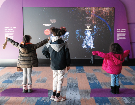 cmnh-article three kids interacting with an exhibit at the Cleveland Museum of Natural History
