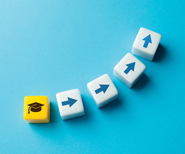 feb25-column-thumbnail A yellow dice with a black graduation hat on it, followed by 4 white dice with arrows moving in a line upward