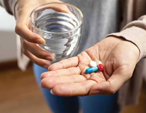 A close-up shot of a hand holding pills