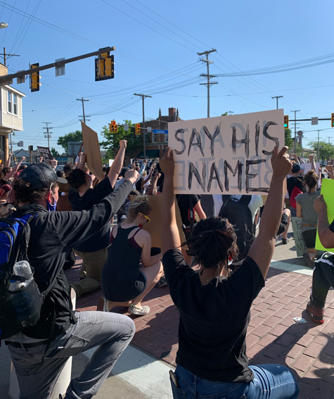 Demonstrators kneel at West 117th Street and Lorain Avenue. 