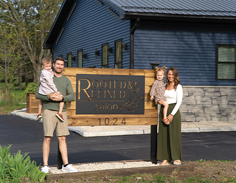 470x365-Article-13 Family posing in front of Rooted & Refined salon sign