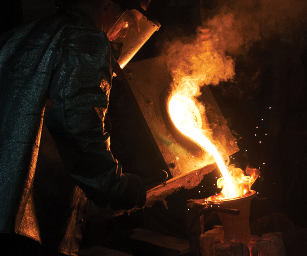 Welder working over fire