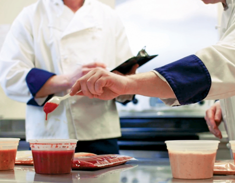 Chefs in the kitchen creating sauces for Signature Sauces