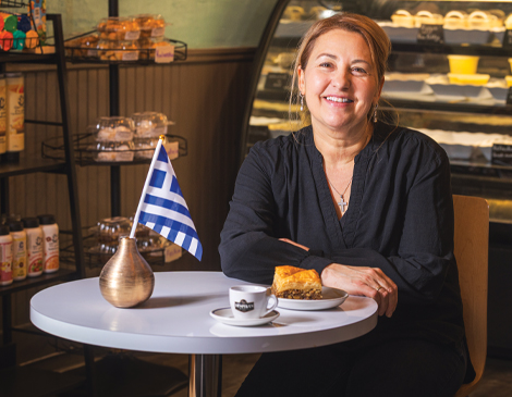 Despina Sarantopoulou sitting in her bakery
