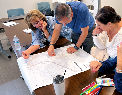 470x365-Article-2 Community leaders looking at wayfinding plans.