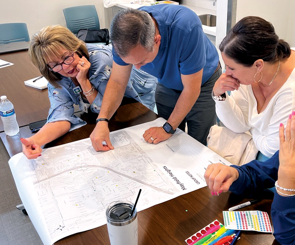 Community leaders looking at wayfinding plans