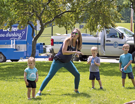 Woman leading a group of children in an exercise class