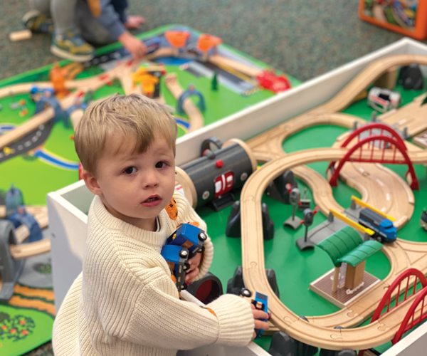 a child playing with trains