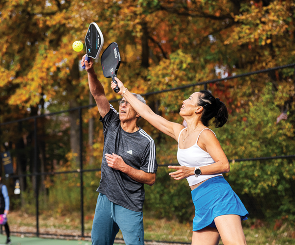 Two people playing pickleball