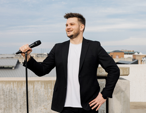 westlake-faces-hayden-article Hayden Grove standing with microphone